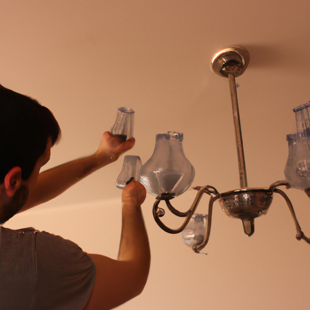Person installing chandelier in room