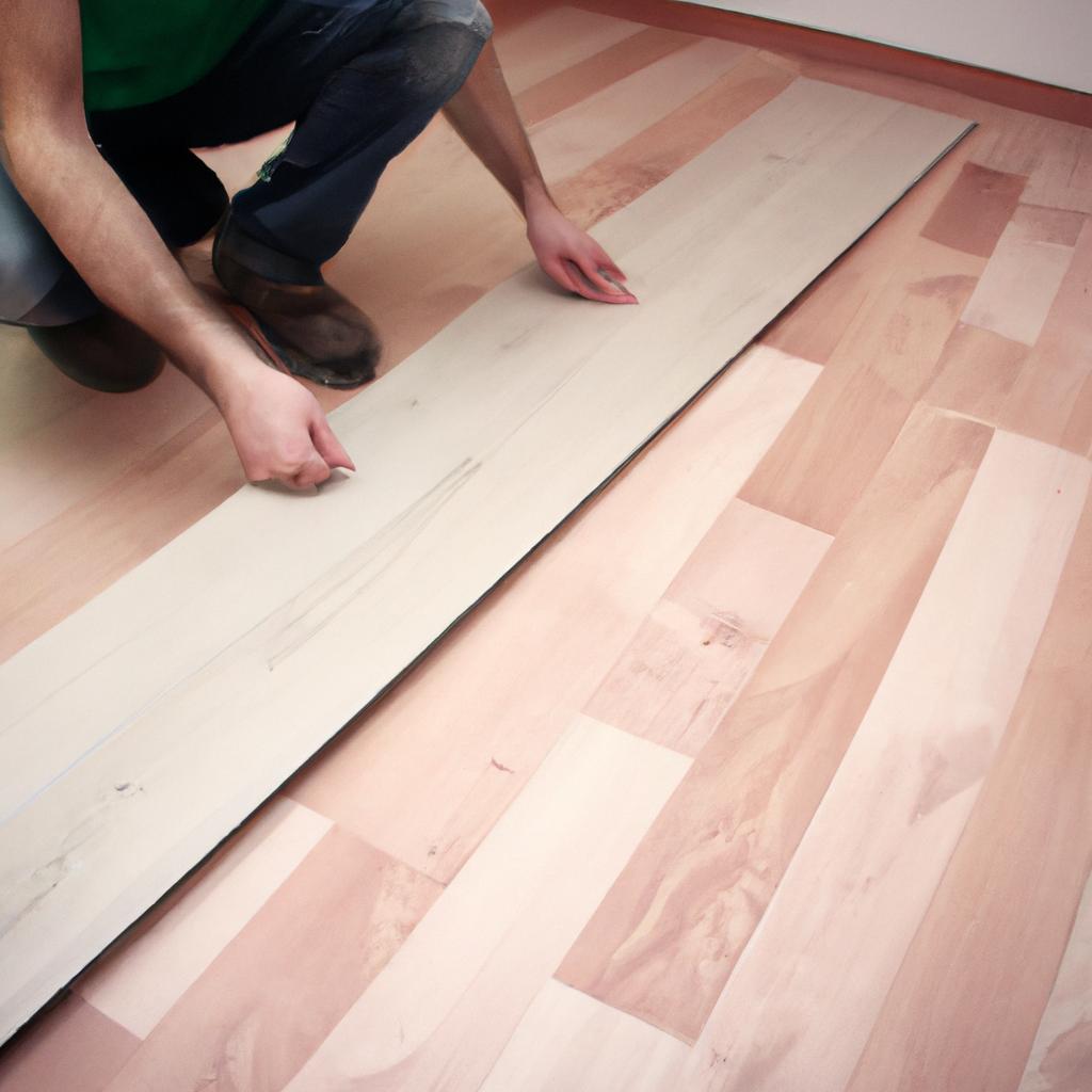 Person installing laminate flooring indoors