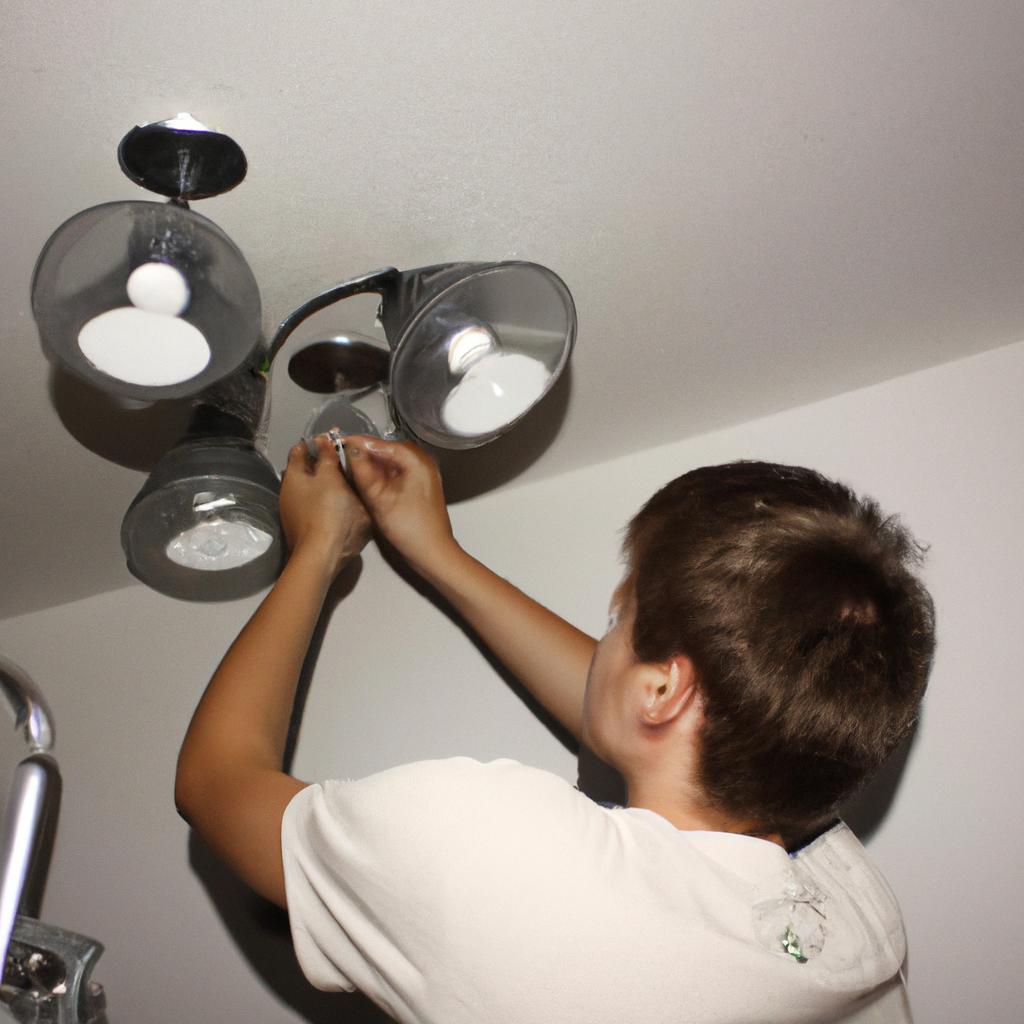 Person installing lighting fixtures indoors